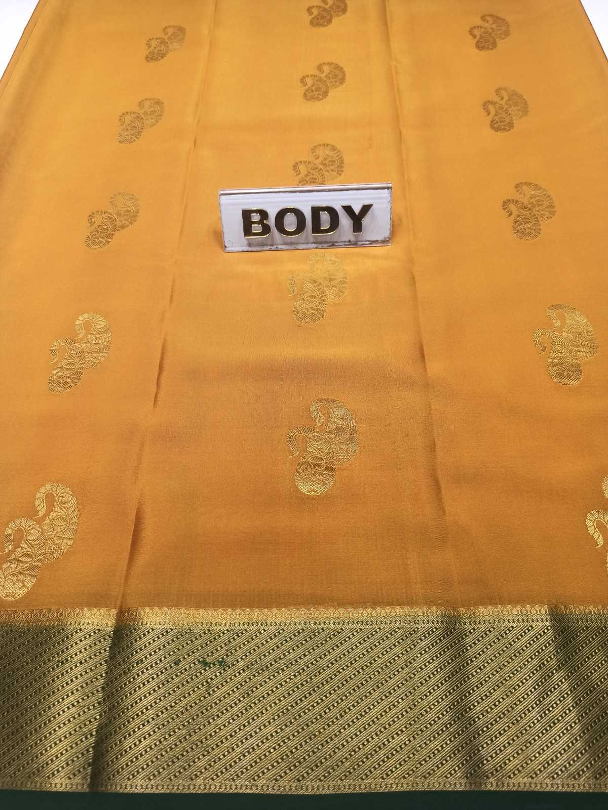 Yellow saree with gold patterns and a label marked 'BODY' on a white background