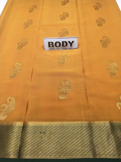 Yellow saree with gold patterns and a label marked 'BODY' on a white background