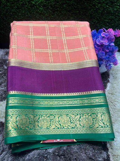 Saree with pink and purple checkered pattern and green border on a dark background