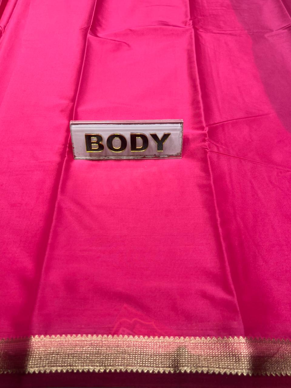 Pink fabric with a label labeled 'BODY' on a pink background