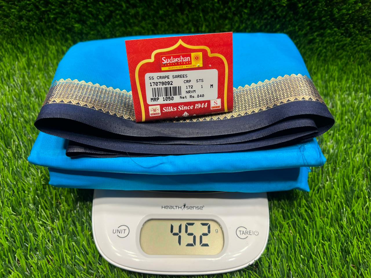 Blue bag with a red label on a green grass background