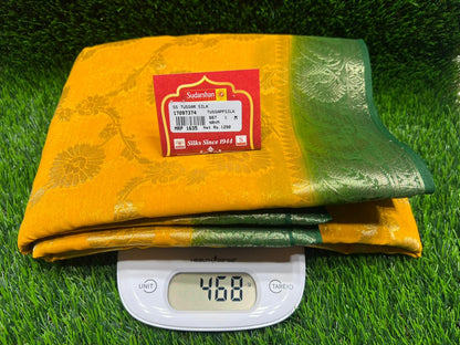 Yellow and green package with a brand label on a green grass background