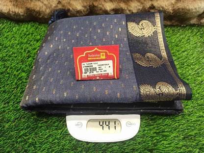 Folded fabric with a label on a digital scale against a grassy background