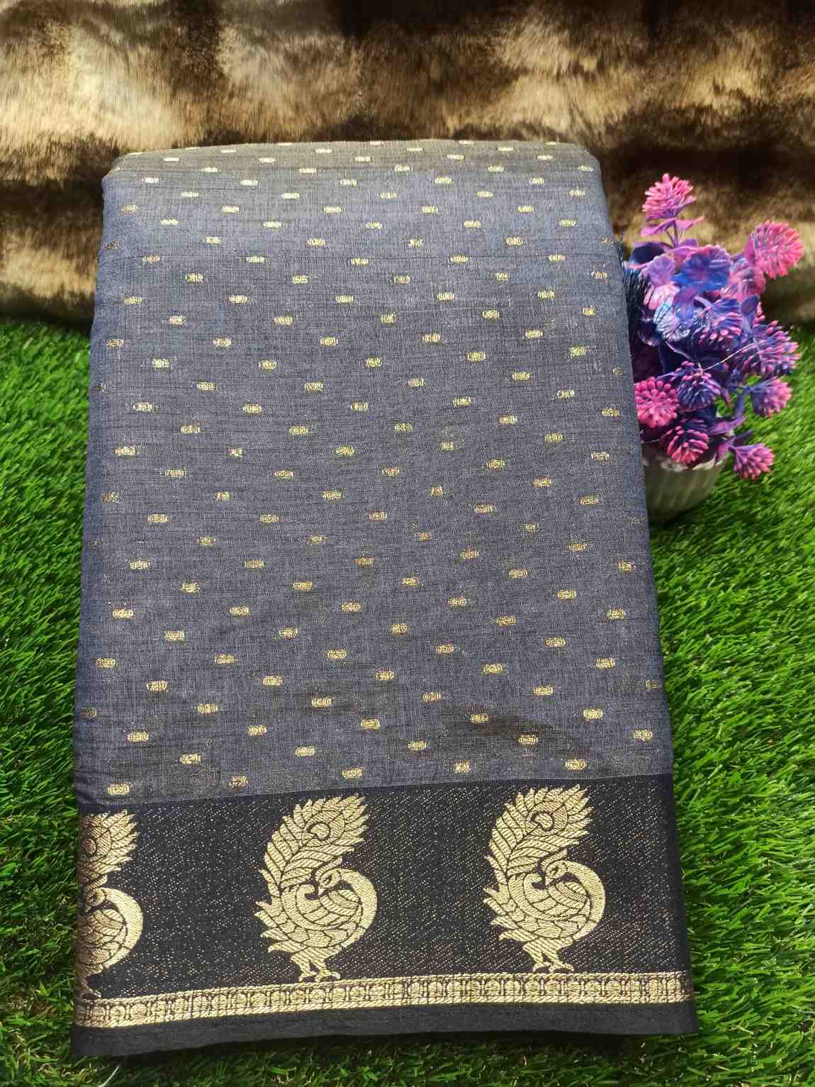 Dark blue fabric with gold patterns on a grassy background