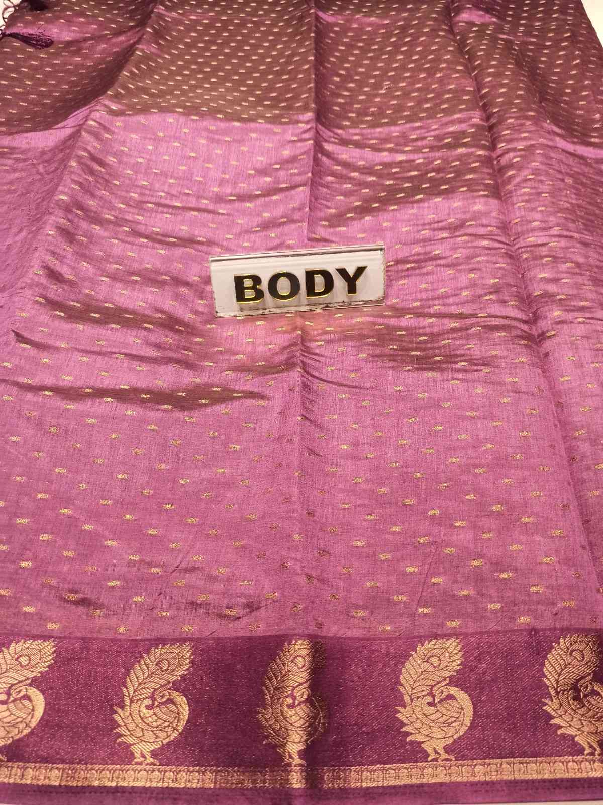 Close-up of a purple fabric with gold patterns and a label labeled 'BODY'.