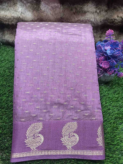 Purple fabric with silver patterns on a green grass background