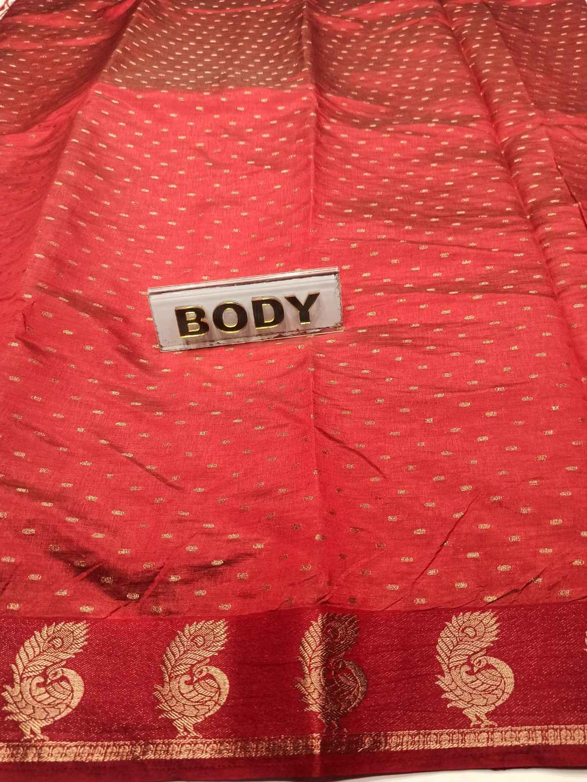Red fabric with gold patterns and a 'BODY' label.