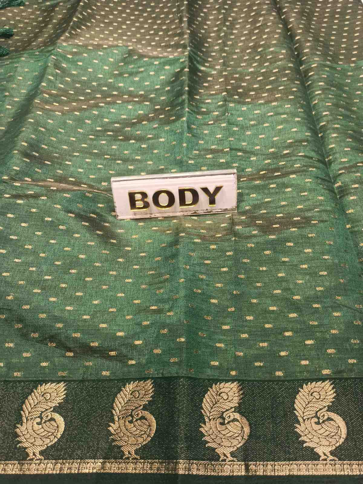 Green fabric with gold patterns and a label reading 'BODY'.