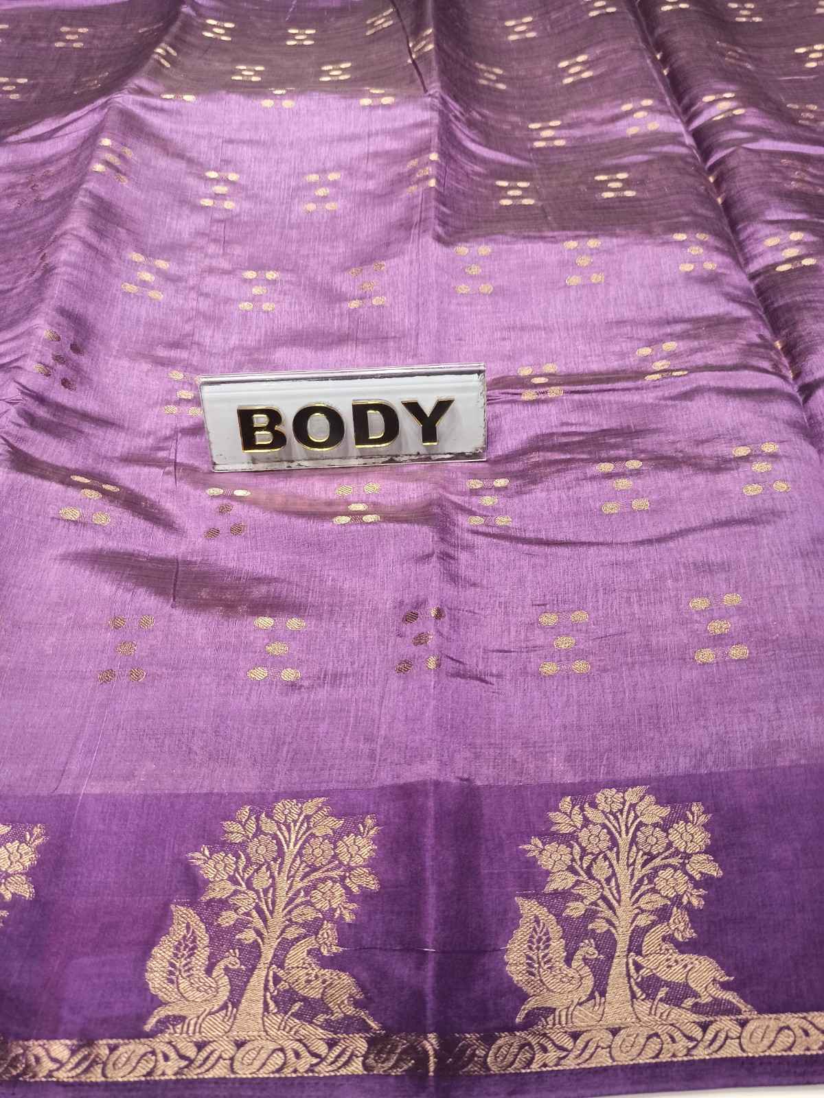 Purple fabric with gold patterns and a label labeled 'BODY'.