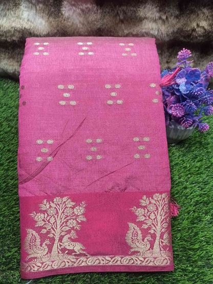 Pink saree with white patterns on a green surface with flowers and fur.