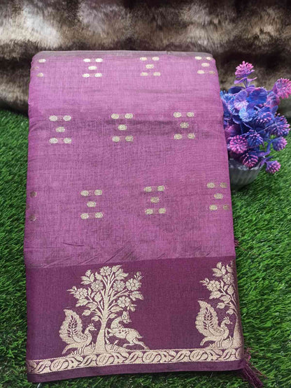 Purple fabric with white patterns on a green surface with flowers