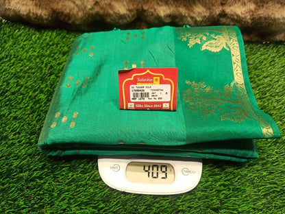 Green fabric with a label on a digital scale on a green surface