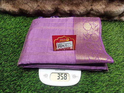 Purple fabric with a brand label on a digital scale against a grass background
