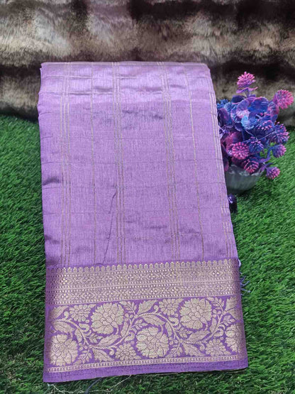Purple saree with floral patterns on a green grass background