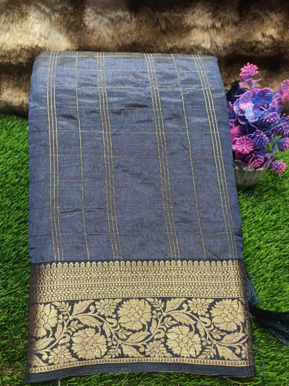 Blue saree with gold border on a grassy background