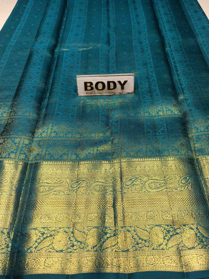 Teal fabric with gold patterns and a label labeled 'BODY'.
