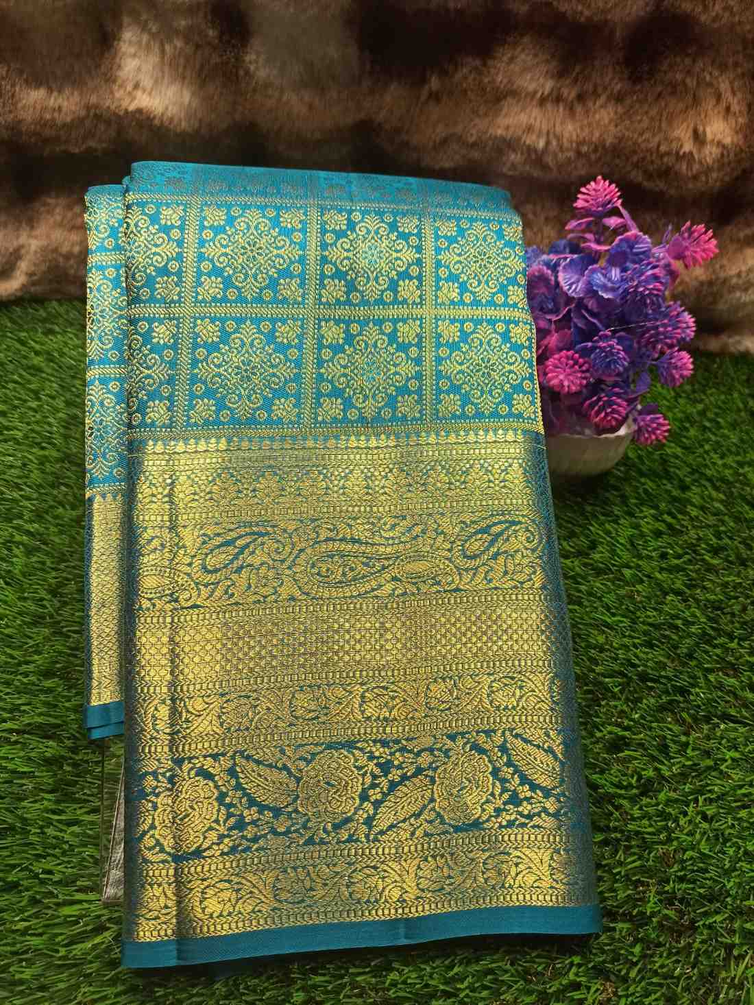 Decorative fabric with intricate patterns on a green surface