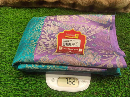Folded fabric with a label on a digital scale against a green grass background