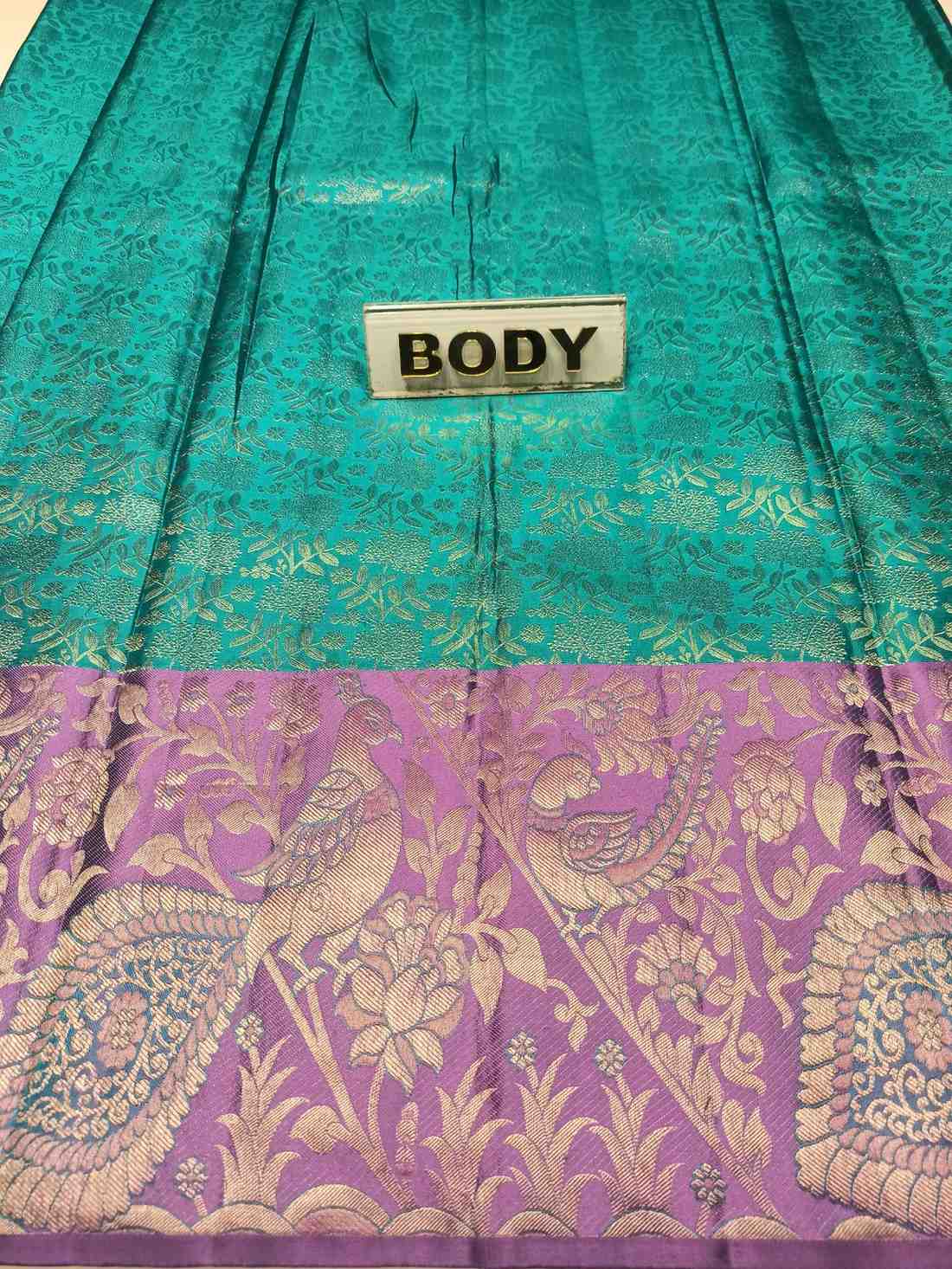 Teal and purple fabric with peacock patterns and a label labeled 'BODY'.