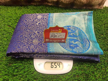Blue and purple fabric with a brand label on a digital scale against a green grass background