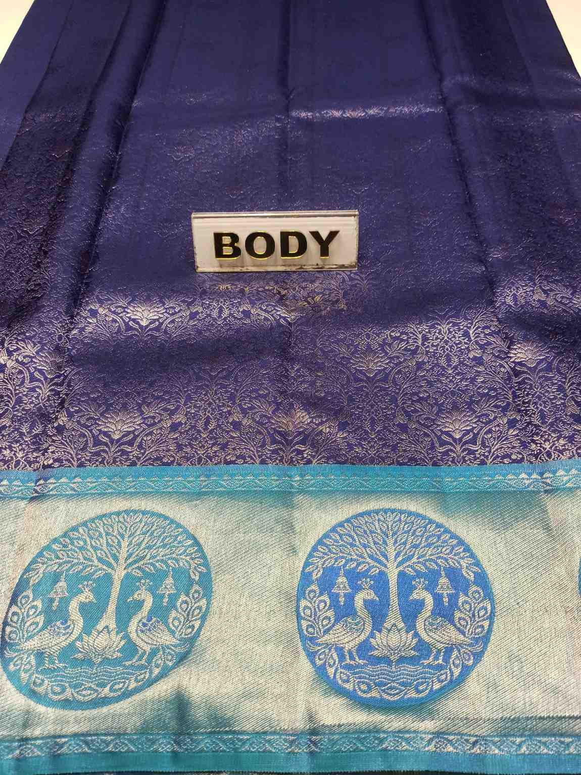 Blue fabric with peacock design and a label labeled 'BODY'.