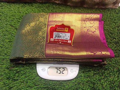 Folded fabric with a brand label on a digital scale against a grassy background