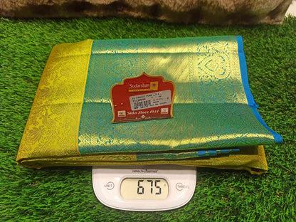 Green and gold fabric with a label on a digital scale on grass