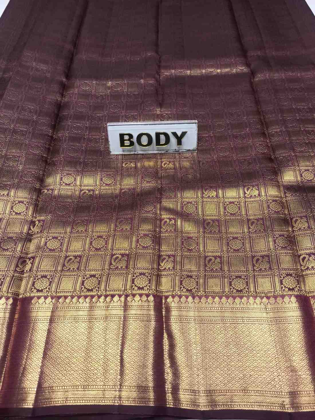 Brown and gold patterned fabric with a 'BODY' label.