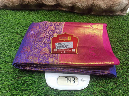 Purple and pink saree with a brand label on a digital weight scale
