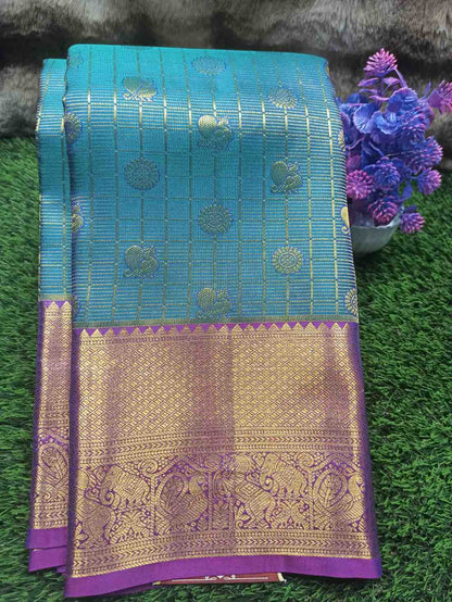 Blue and purple saree with intricate patterns on a green grass background