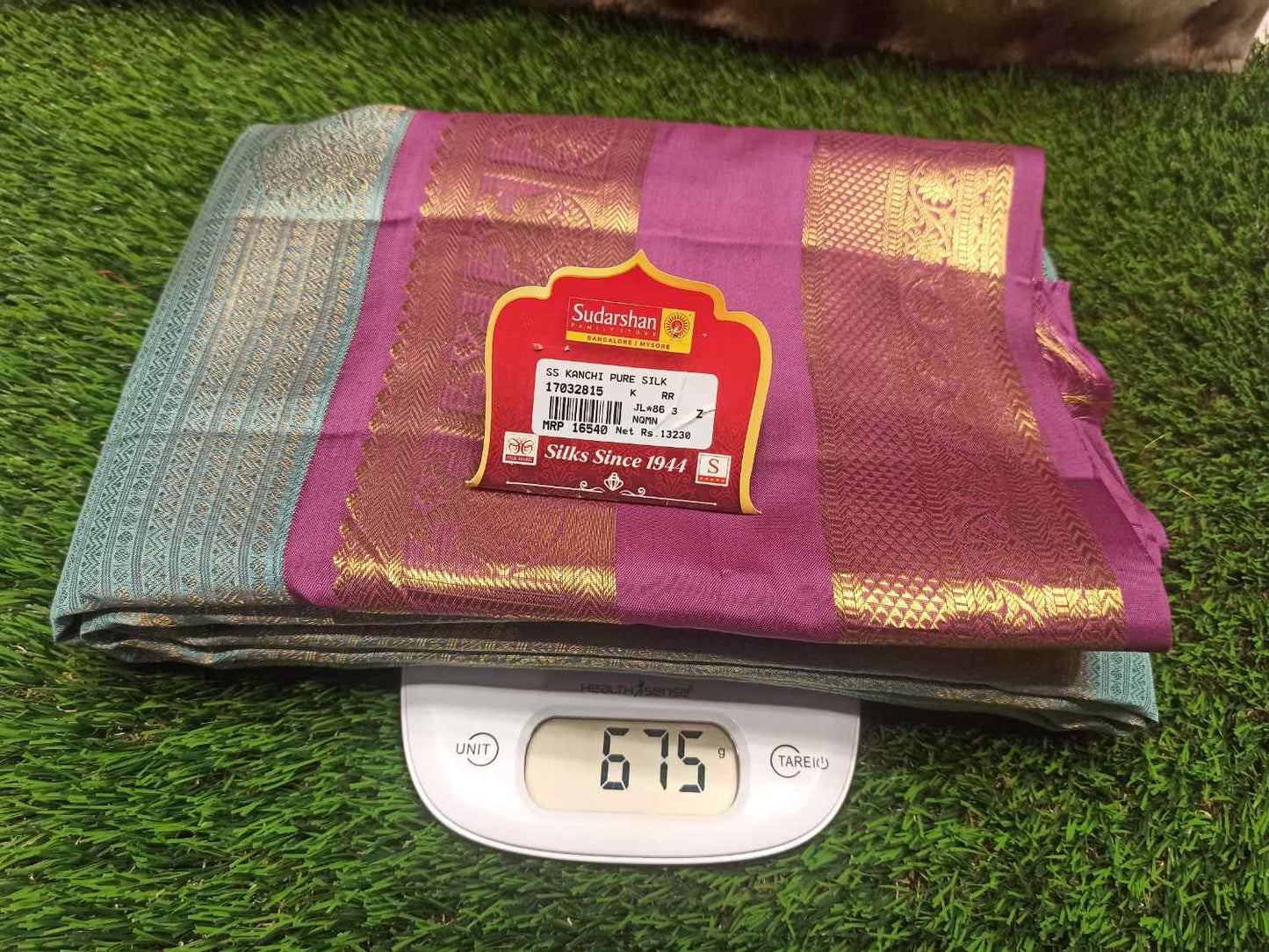 Folded fabric with a label on a digital scale on grass